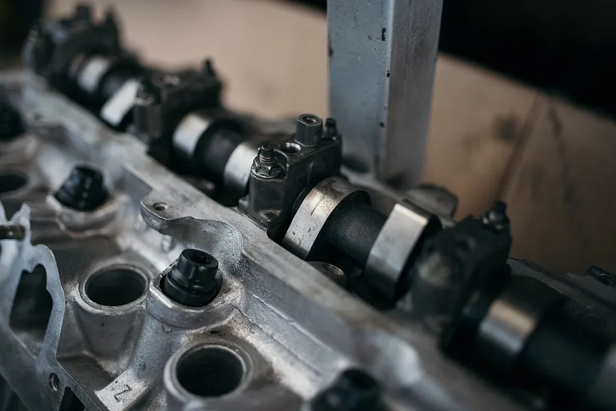 Cylinder head with camshaft on a workbench in the workshop